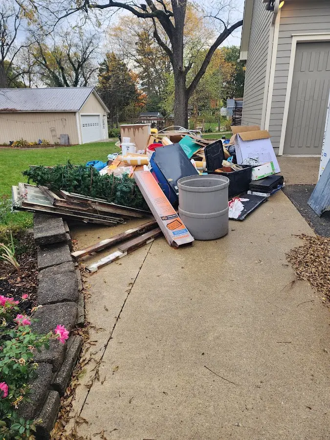 Dumpster being loaded with debris for Estate Cleanout Dumpster Rental in Nashville